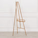 Side view of bright gold metal easel showcasing adjustable shelf and sleek design

