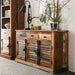 A large sideboard made of reclaimed wood with three drawers and multicolored panels, placed in a room with various decor.
